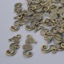 Pendant hardware 'Seahorse', 22x10 mm diameter, hole diameter 2.1 mm, pack of 26 pcs ±, bronze-colored metal