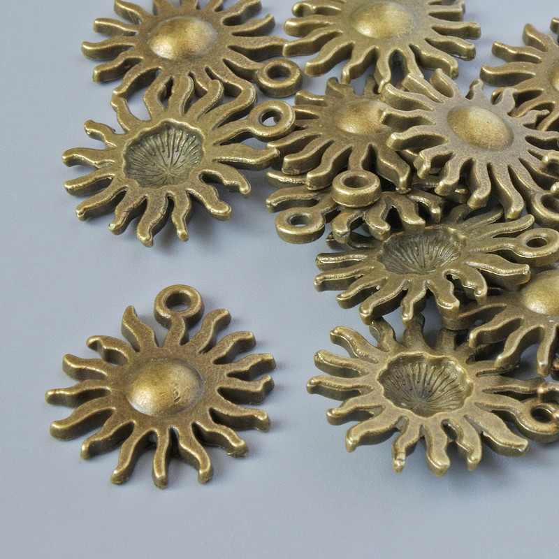 Pendant fittings 'Sun', 17x13 mm, hole diameter 1.5 mm, packaging 13 pcs +/- bronze-colored metal