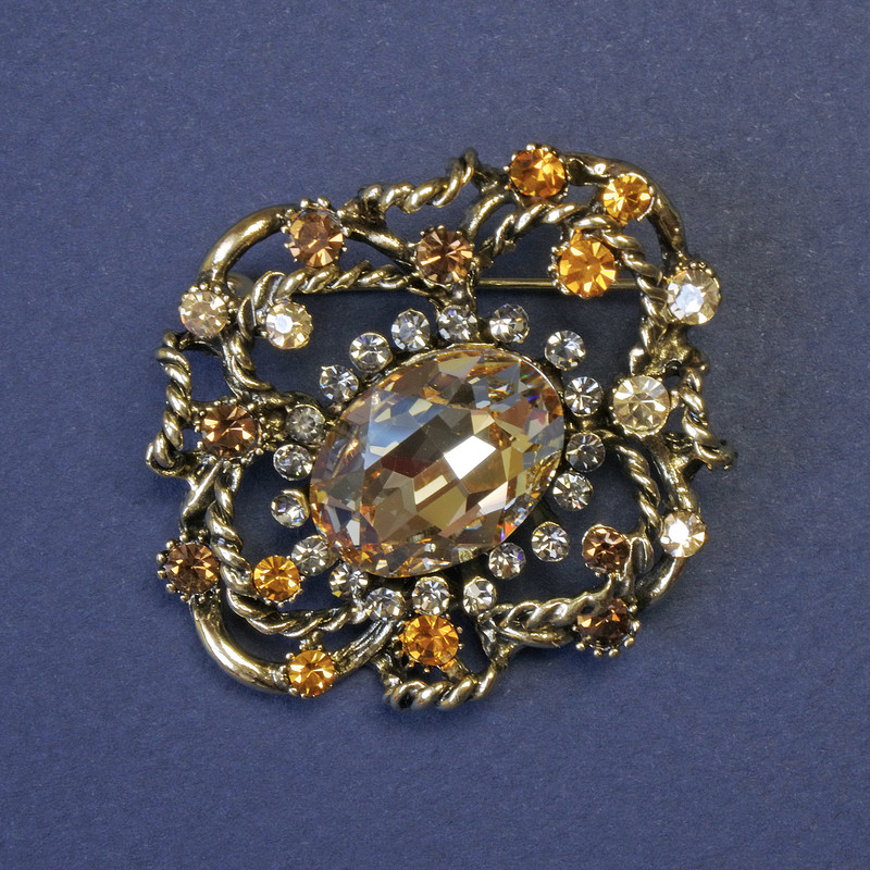 Brooch Accent with a Large Yellow Crystal and Rhinestones 44x38mm+- Gold-Toned Metal
