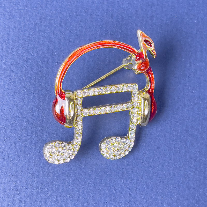 Brooch 'Note in Headphones' white crystals red enamel gold-tone metal 27×32 mm+