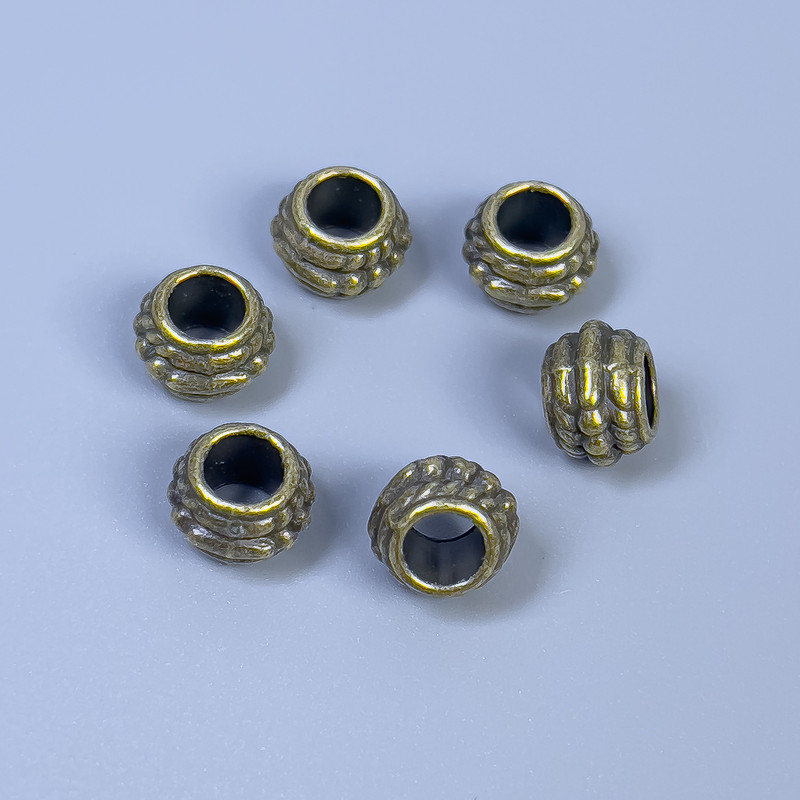Bronze-colored bead insert hardware, 8×6 mm diameter with hole approximately 4 mm, packaging 20 g (~ 26 pcs)