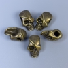 Skull-shaped bead insert, bronze color metal, size 12×18×8 mm ±, hole diameter 4 mm ±, packaging 20 g (~5 pcs)