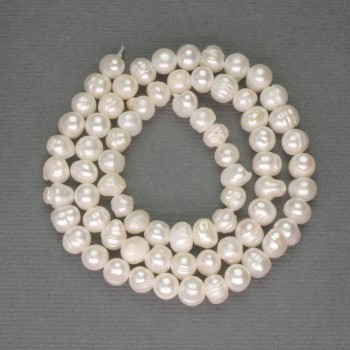 Freshwater white oval pearls on a thread, diameter approximately 5–6 mm, length 35 cm+