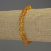 Faceted Amber Bracelet 7x5 mm +/- with 2 mm seed beads +/-, elastic length 18 mm +/-