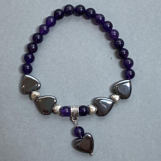 Amethyst bracelet with smooth beads 6mm +/-; Hematite heart 12mm +/-; with metal inserts Length 18mm +/- Stretch