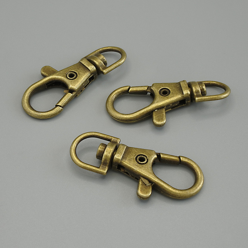 Price per pack / 10 pcs. Bronze-colored carabiner clasp, diameter 38x18 mm