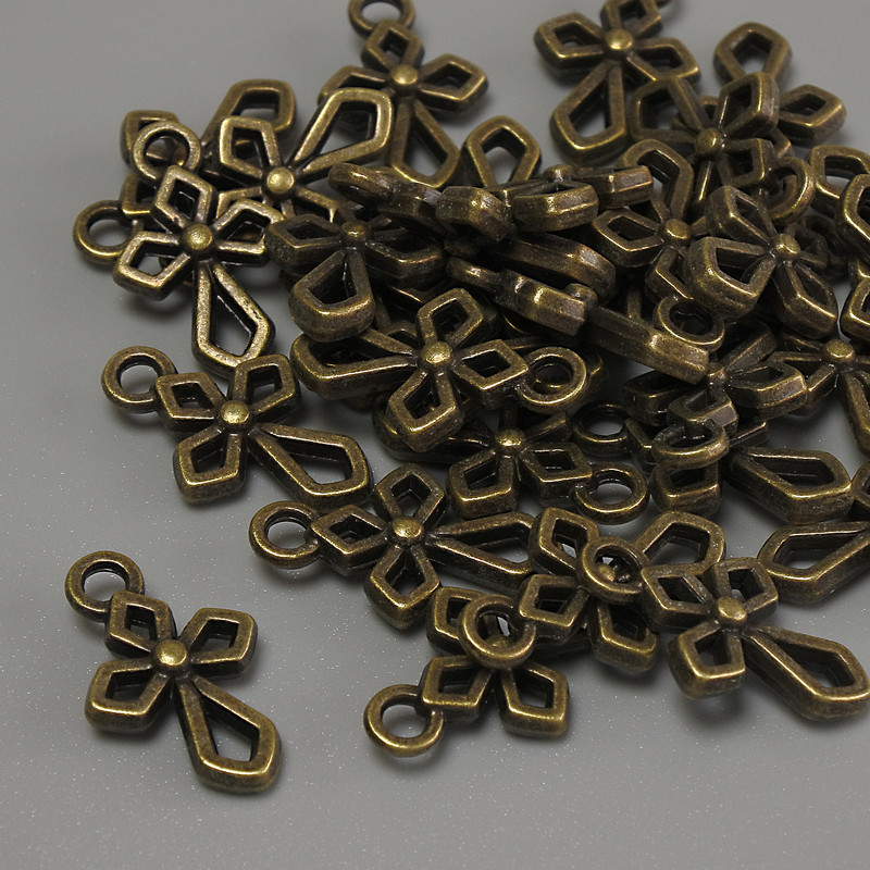 Cross-shaped pendant finding in bronze metal color, size 16 x 10 x 2 mm, hole diameter 2 mm, packaging 20 g (~31 pcs)