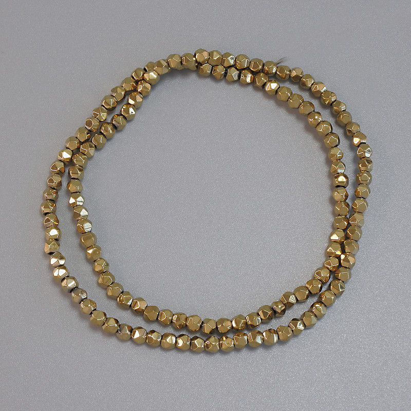 Gold-colored hematite beads, faceted 3×3 mm ± on thread, length 38 cm+