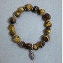 Tiger's Eye Bracelet with Faceted Beads 9×8 mm ± 12×10 mm ± with Metal Inserts, length 18 mm ± Stretch