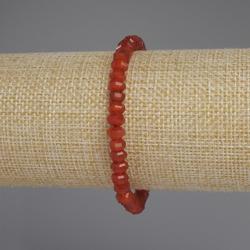 Bracelet with faceted carnelian rondel, 6x4 mm diameter, 18 mm length, stretch