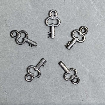 CLEARANCE! Key-shaped pendant hardware, plastic, dark silver color, dimensions 20x11x3 mm ±, hole diameter 3 mm ±, packaging 0.5 kg