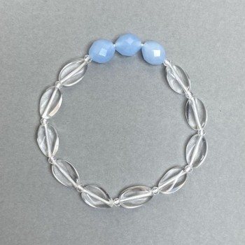 Bracelet with twisted oval rock crystal, 12x8x4 mm + faceted aquamarine bead 10x8.5 mm, 18 cm stretch