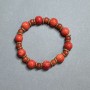 Bracelet with imitation coral beads (10 mm) and rondelles 7×5 mm, with metal inserts, 18 cm stretch