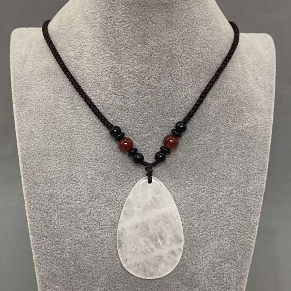Teardrop pendant with white quartz 55x35mm (+-) on a cord with a carnelian bead, 65 cm long+