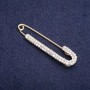 Brooch-pin with white crystals, 75×16 mm, gold-tone metal
