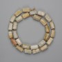 Fossilized coral beads, faceted cut, 10–11 × 5–7 mm ±, 3 mm seed beads, length 40 cm ± on thread