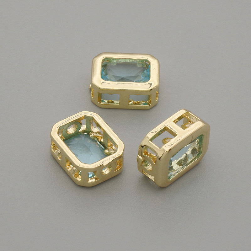 Bead insert with blue crystal, gold-tone metal, 9x7 mm diameter ±, hole diameter 1.3 mm ±, per 1 piece