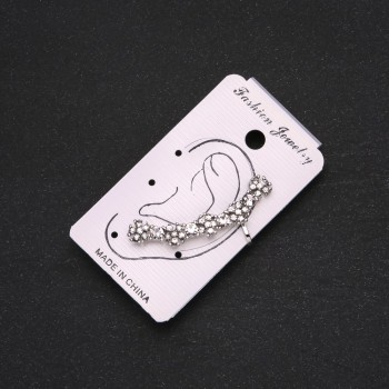 Silver ear cuff with white crystals and white flowers