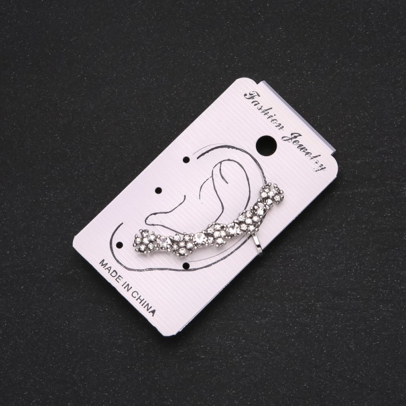 Silver ear cuff with white crystals and white flowers