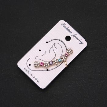 Gold-tone ear cuff with white flowers, multicolored crystals