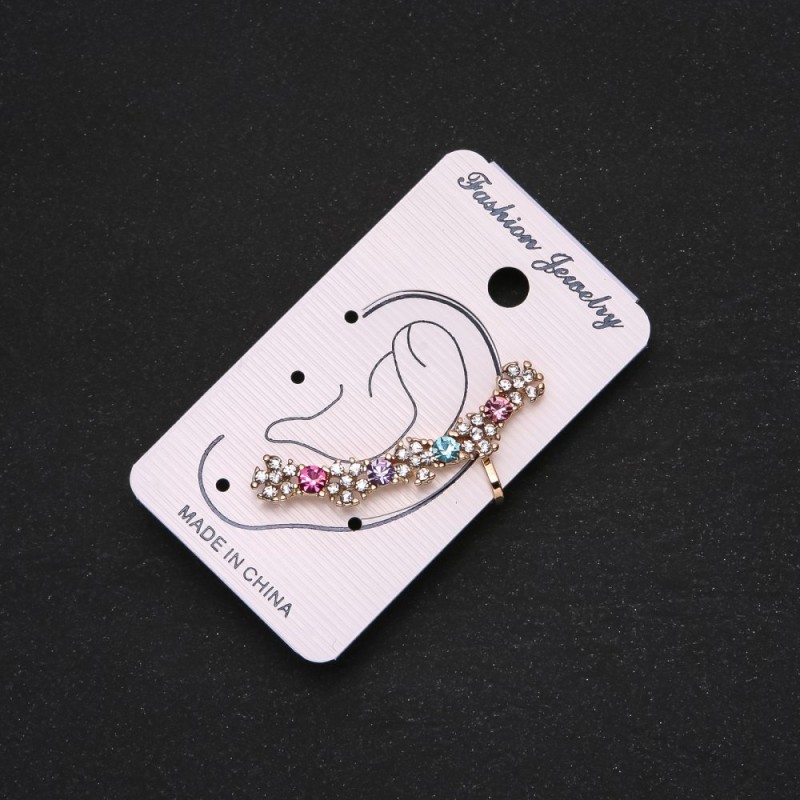 Gold-tone ear cuff with white flowers, multicolored crystals