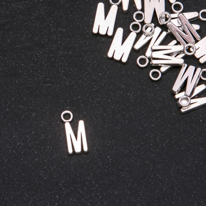 Pendant finding Letter 'M' 17x7mm packaging 20 g (+/- 15 pcs.)
