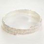 Spiral bracelet with four turns, small white crystals, 18-22 cm circumference
