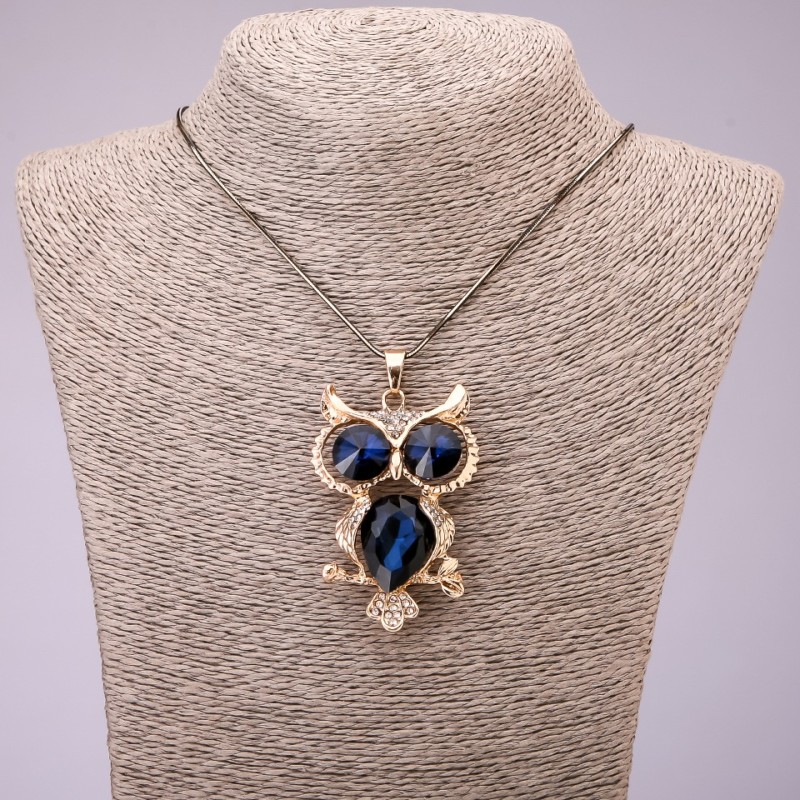 Pendant 'Owl' with blue crystals on a long chain of black-gold metal, diameter 41×62 mm, length 70 cm