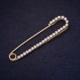 Brooch pin 71x16 mm, rhinestones, white color, gold-tone metal