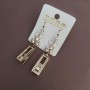 Drop earrings with white crystals in gold-tone metal, 9x57 mm