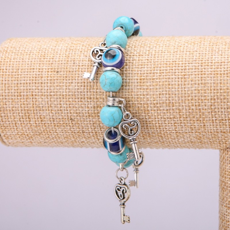 Turquoise amulet bracelet with blue 'Little Eyes' on elastic, diameter 10(+-)mm, length 18 cm with inlays and pendants
