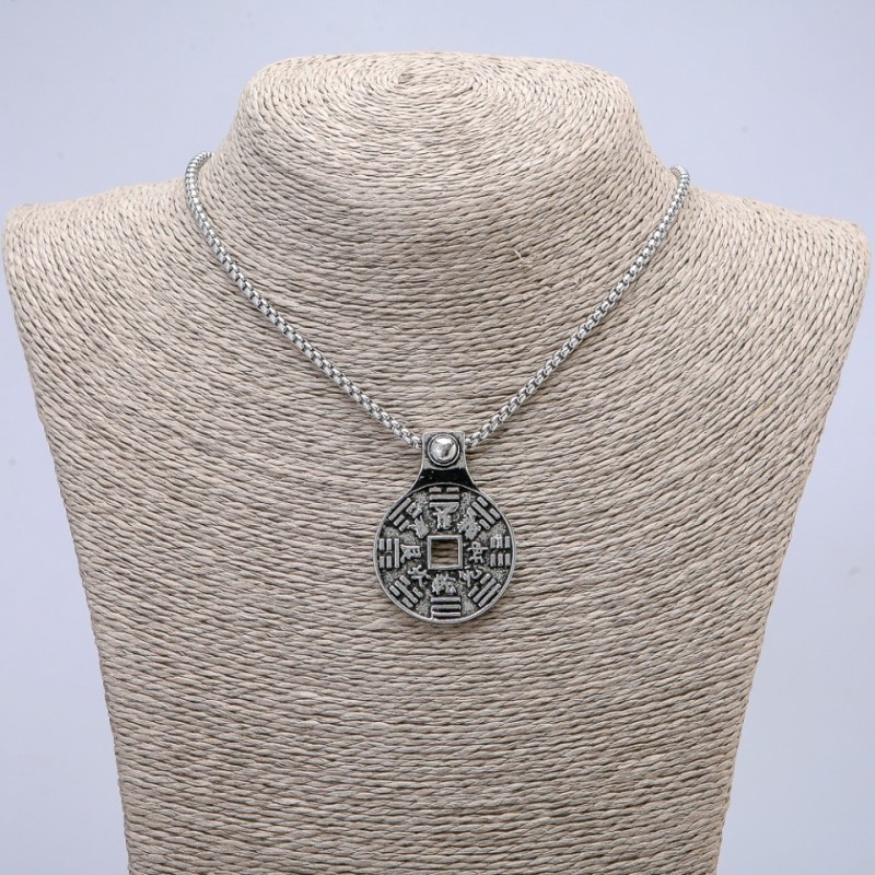 Pendant 43x30 mm on a chain, length about 70 cm; silver-colored metal.