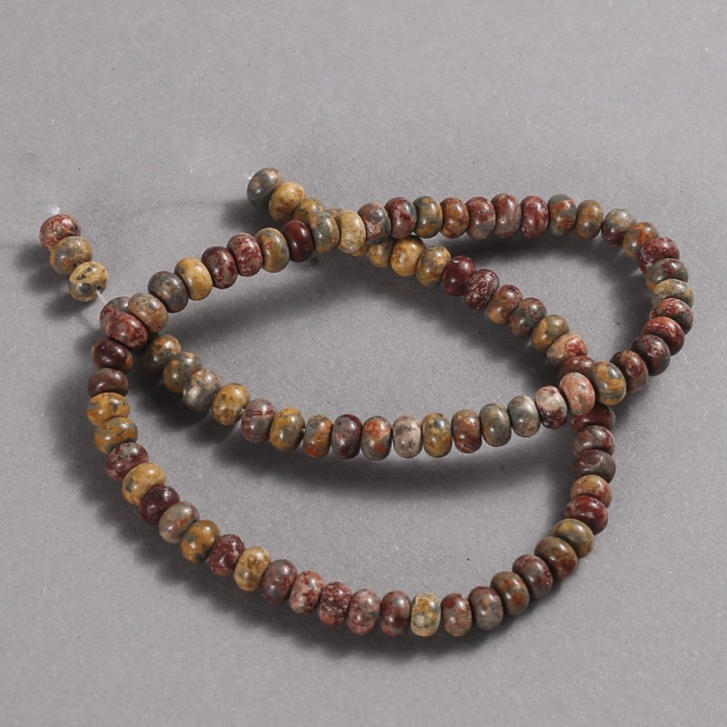 Beads on a strand of natural Mookaite Jasper, diameter 6x4 mm, length 39 cm.