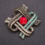 Brooch with red crystal and blue and gray rhinestones, 47×59 mm, yellow metal