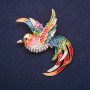 Brooch 'Fire Bird' with crystals and enamel, color red, blue, green, and yellow, 60x48 mm, gold-toned metal