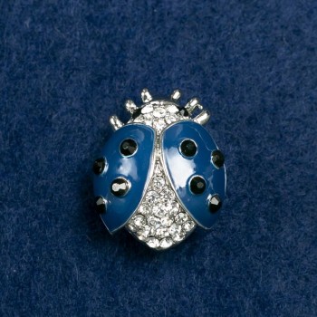 (20/25 mm) Sun-shaped brooch in light metal, adorned with stones, blue enamel