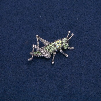 Brooch "Grasshopper" in silver-toned metal with black, green, and petrol rhinestones, 44x27mm +