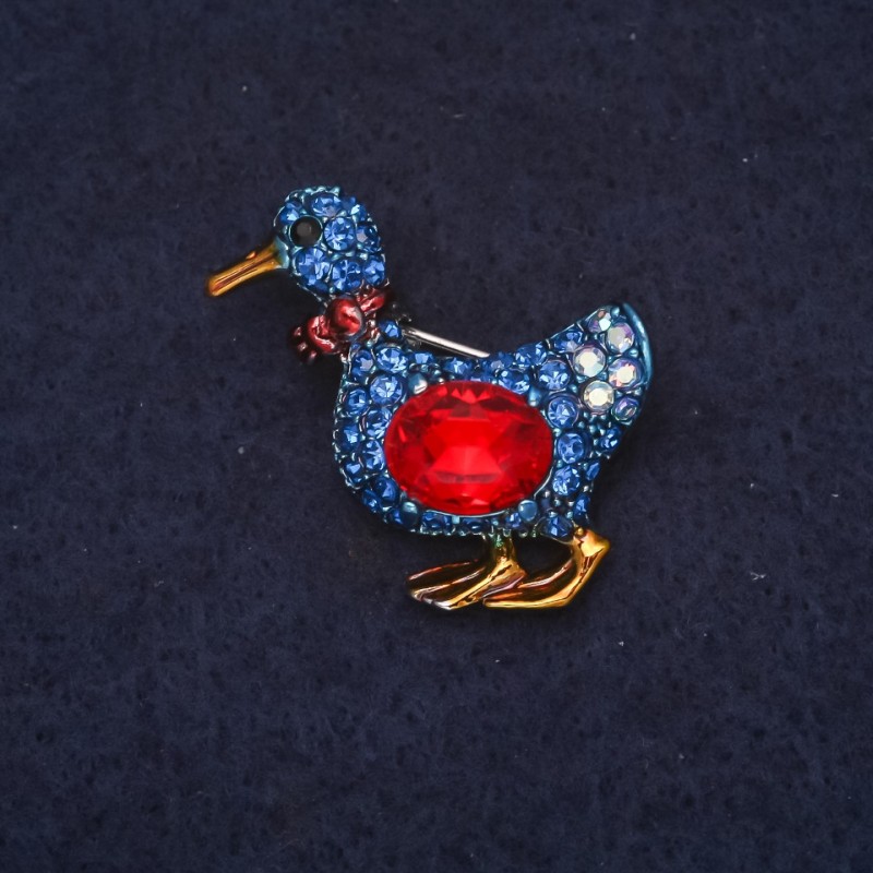 Duck-shaped brooch with blue rhinestones and red crystal 24x30mm