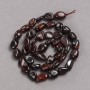 Beads on a thread of natural Bull's Eye stone, faceted, diameter 10×8 mm + -, length 39 cm +