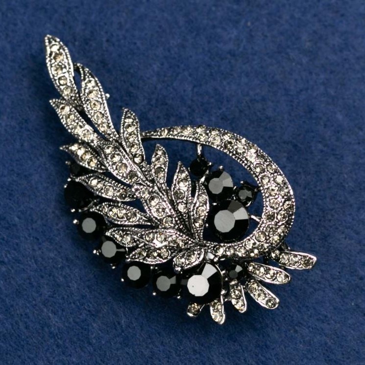 Brooch 'Leaves' with white and black crystals, silver-colored metal 72x37mm