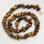 Beads of natural Tiger's Eye stone, strung on thread, diameter 11x5 mm, length 40 cm