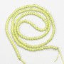 Small synthetic spinel beads, yellow lime, faceted spheres, 2 mm diameter, on a thread, length 37 cm