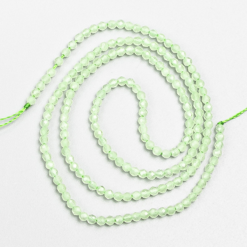 Small spinel beads (synthetic) pale-green faceted spheres, 2 mm diameter, on a thread, length 37 cm