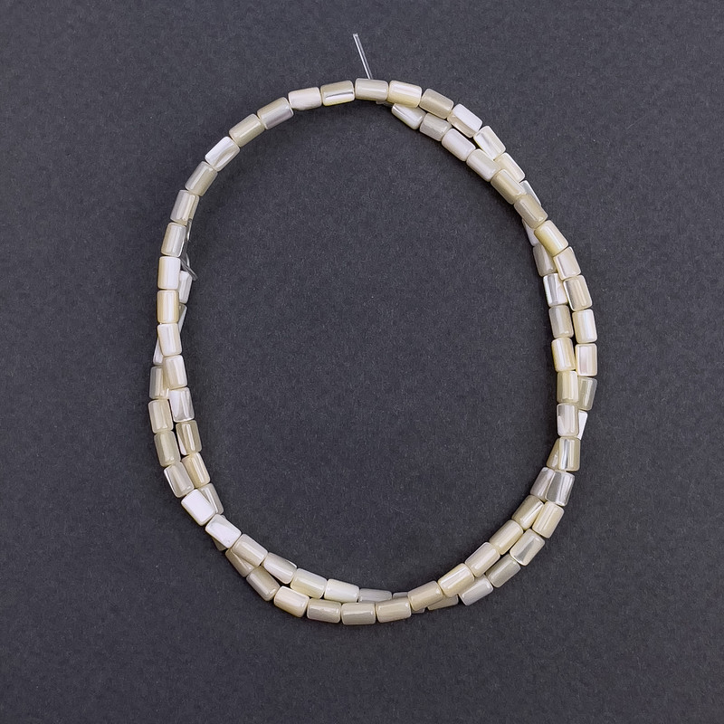 Beige mother-of-pearl beads, cylindrical, 3x5 mm diameter, length approximately 40 cm on a thread