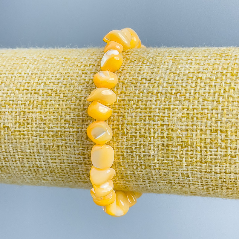 Light orange mother-of-pearl bracelet with faceted beads, 8x6 mm, stretch, 18 cm long