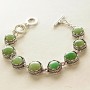 Clearance. Jade bracelet in a 'tooth' setting with 7 round stones, 15 and 14 mm, length 18-21 cm