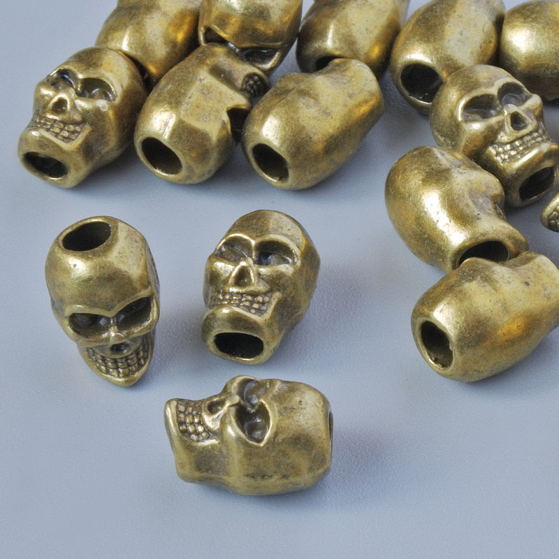 Bead-insert finding 'Skull', 9x6 mm, hole diameter 2.6 mm, pack 18 pcs +- bronze-colored metal