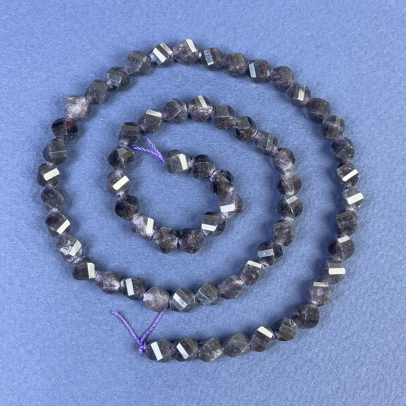 Iolite faceted diamond-shaped beads on a thread, length 38 cm+