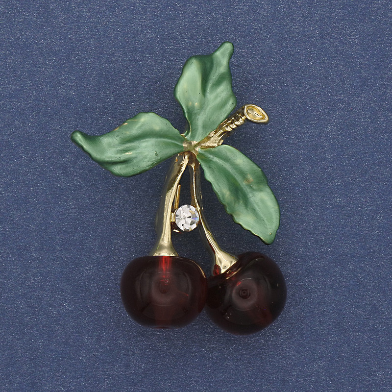 Brooch 'Cherries' with green enamel and white crystals in golden metal, 39x28mm+