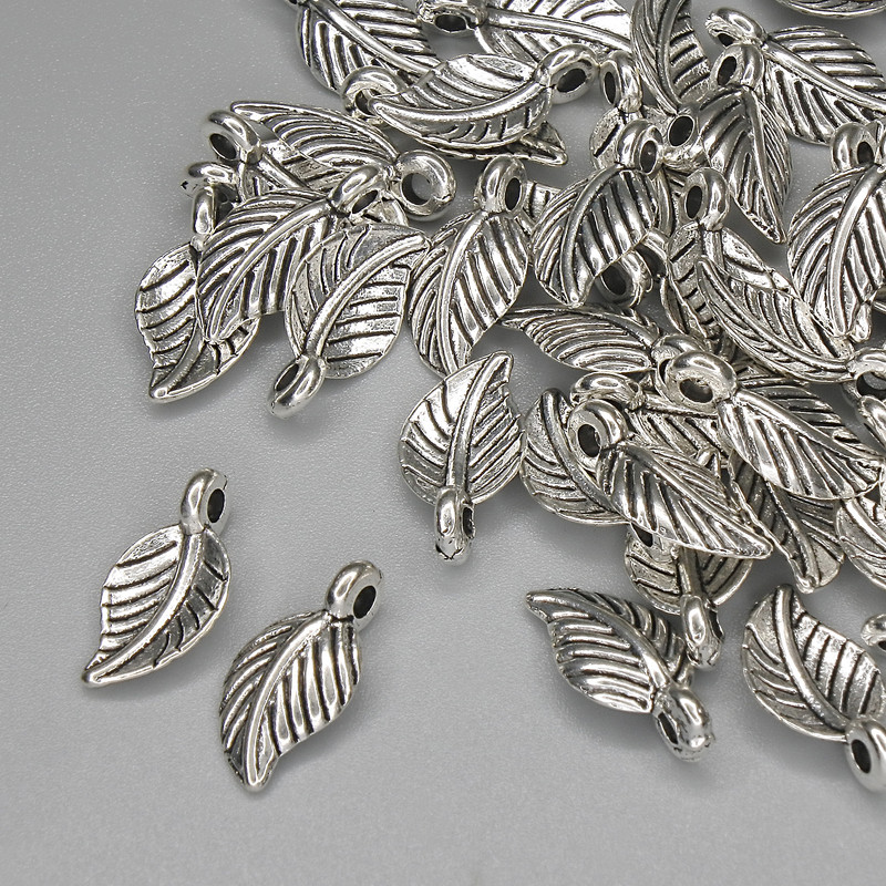 Leaf pendant, bronze-colored metal, diameter 15×7 mm, +/- packaging 46 pcs